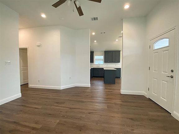Featuring recessed lighting, dark wood-style flooring, and ceiling fan