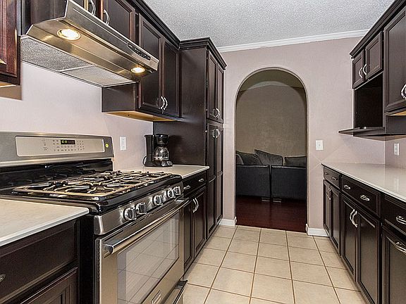 Custom cabinets include full pantry and appliance shelf.