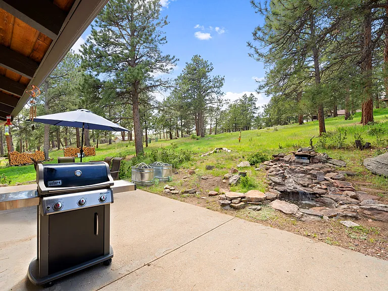 Grill outside of 1 of 3 sliding glass doors.