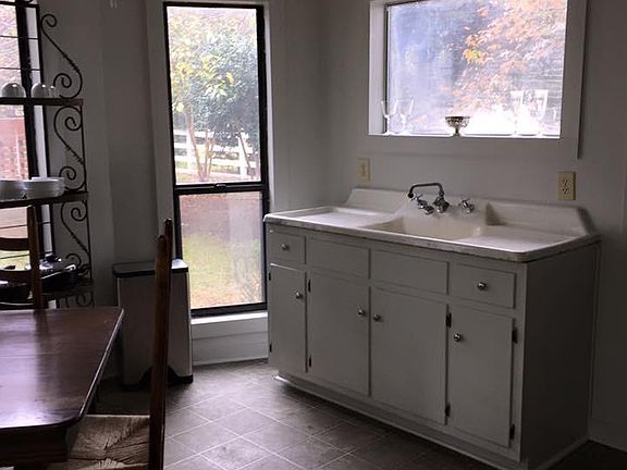vintage sink with window view of the horse paddocks