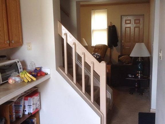 View from kitchen into living room, shows railing to steps t