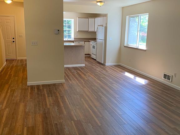 Living Room view towards dining room and kitchen. 1/2 bath is in the hallway to the left
