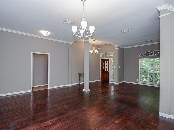 Just off the cheery foyer is an oversized doorway that showcases the formal dining room. A stunning chandelier warms this colorful gathering space.