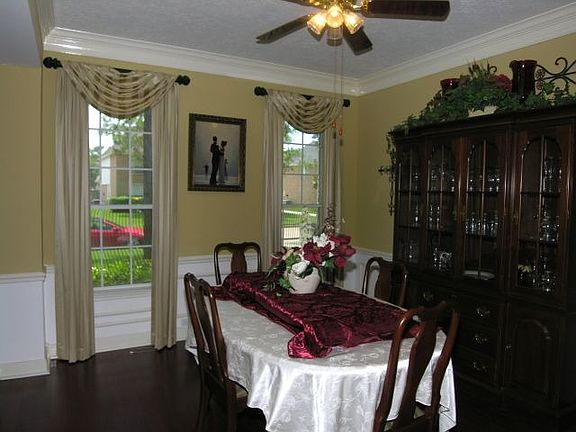Beautiful Formal dining room with wood flooring, crown molding.