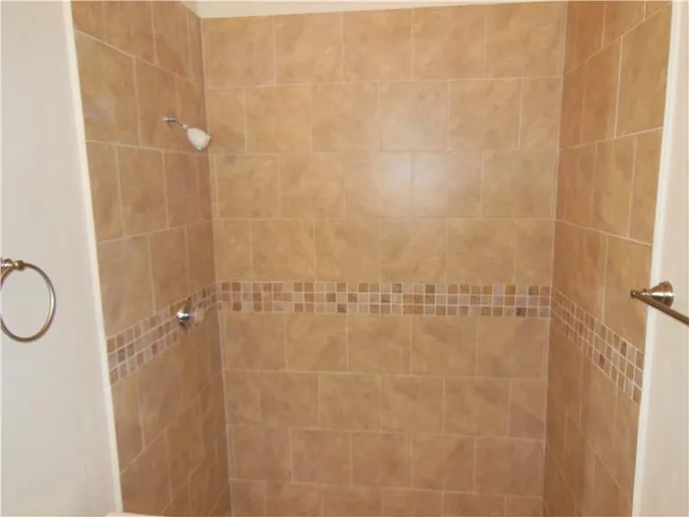 First floor updated full shower bath adjacent to bedroom.