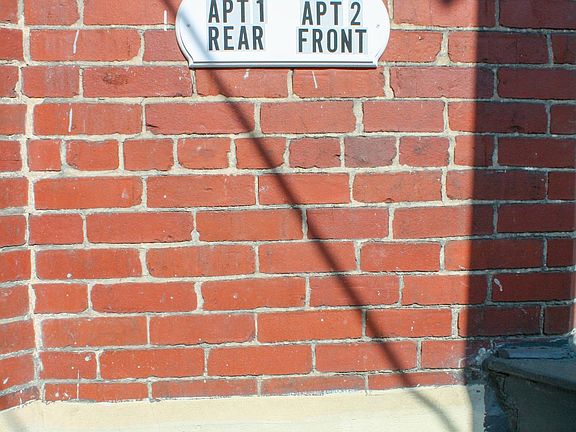 Apartment entrance is at the rear of the building.