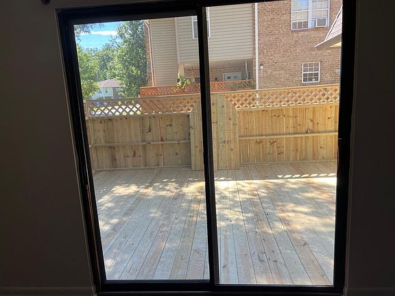 Doors from the living room leading to the deck, complete with 6ft tall privacy fence.