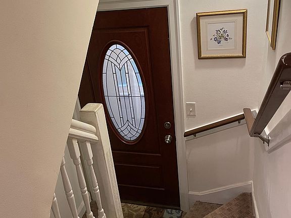 Looking down at entry door from main level of apartment (entry door located at top of outside covered stairway to the second floor).