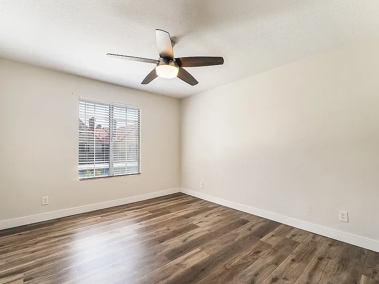 Se cond Bedroom with large window and ceiling fan with light