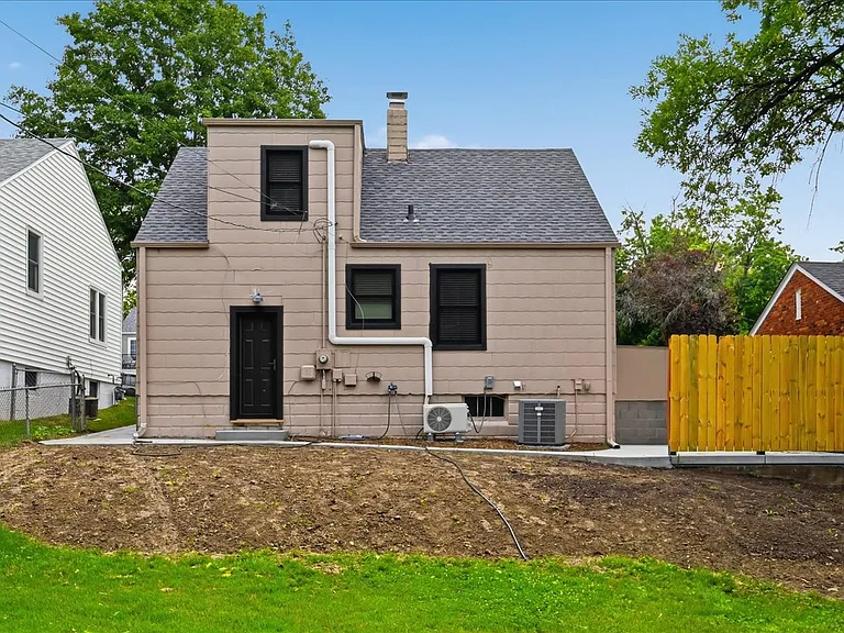Back view of house. Sod has been added and established in all previously bare areas.