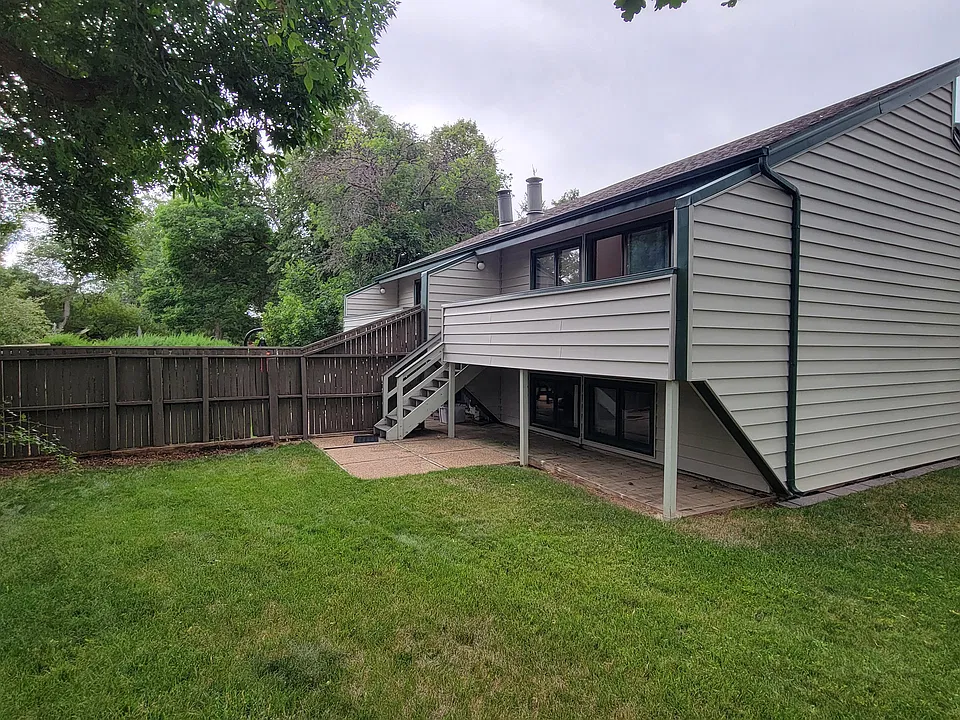 Back yard, deck, spacious grassy area.