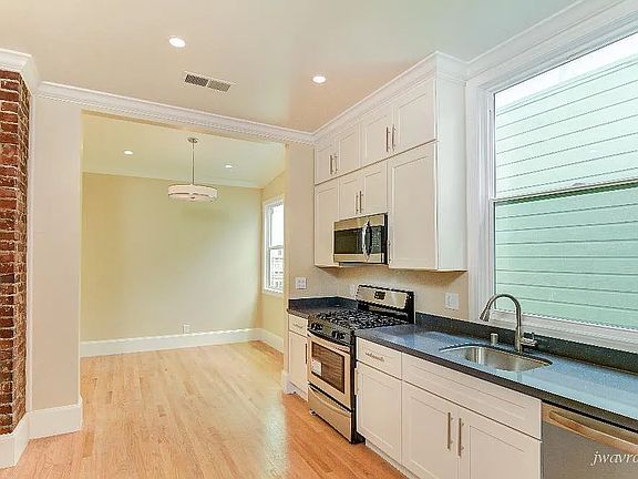 Kitchen with dining area at he back wall