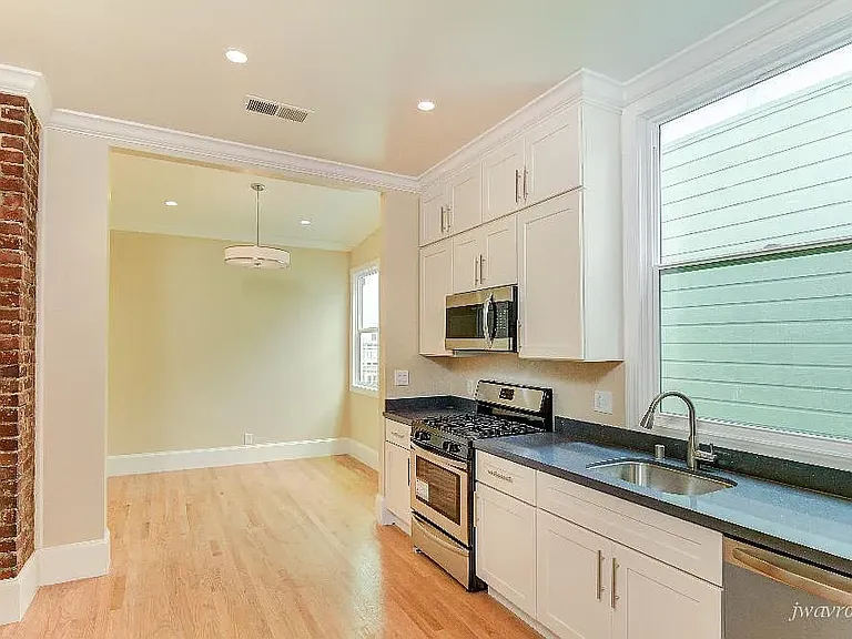 Kitchen with dining area at he back wall