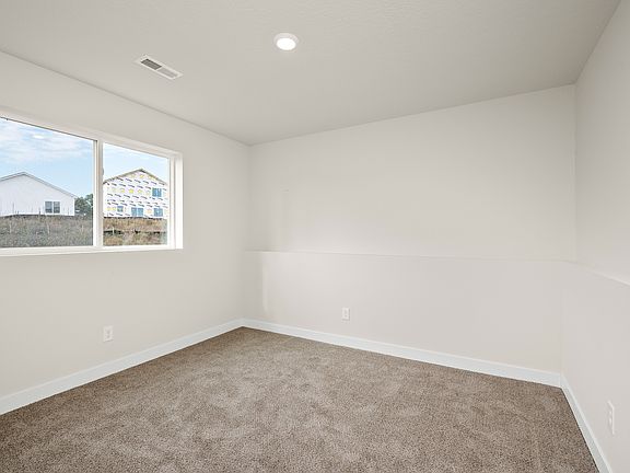 The master bedroom is spacious with a large window.