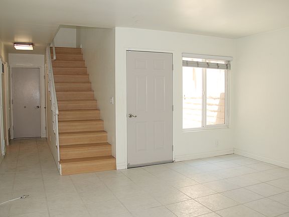 Hallway to 1/2 bath powder room, closet under the stairs and garage with washer and dryer units
