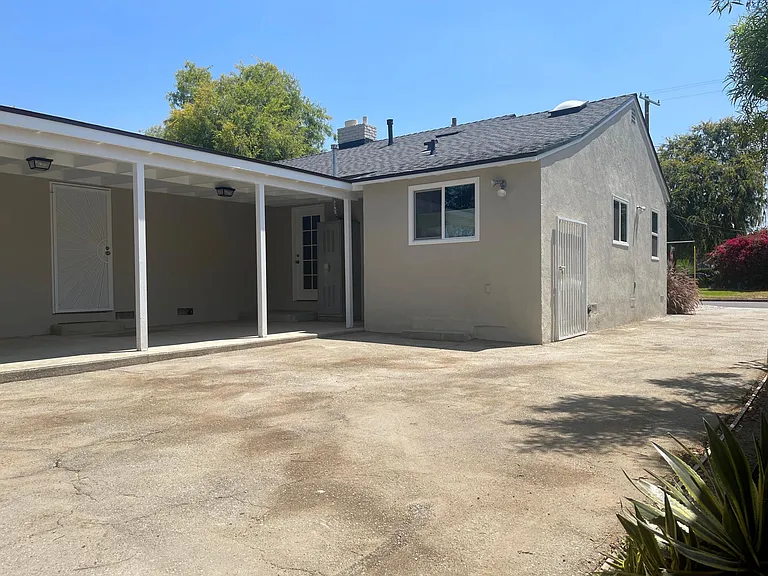 Covered patio great for entertaining with access from both main bedroom and den.