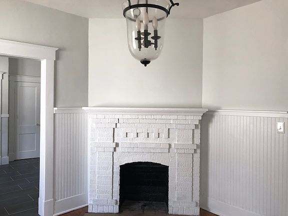 Dining Room: Beadboard wainscotting. Decorative fireplace. Hardwood floors.
