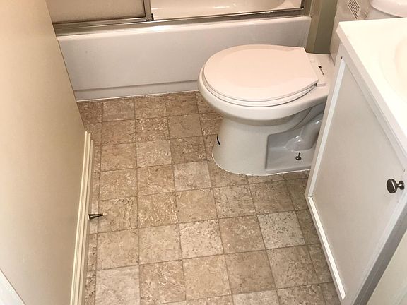 Bath with new floor, glass shower door
