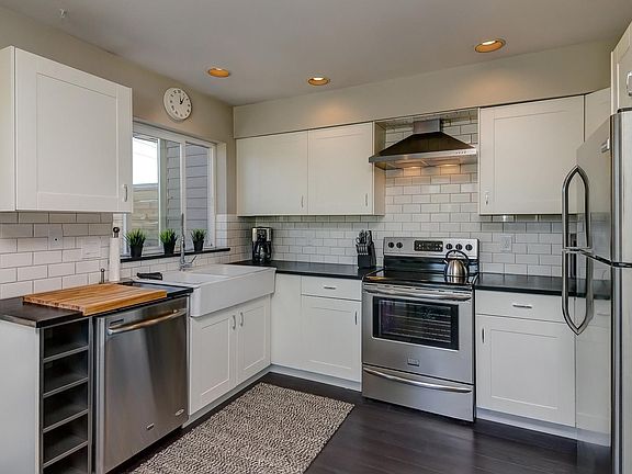 Large kitchen with stainless steel appliances and granite countertops