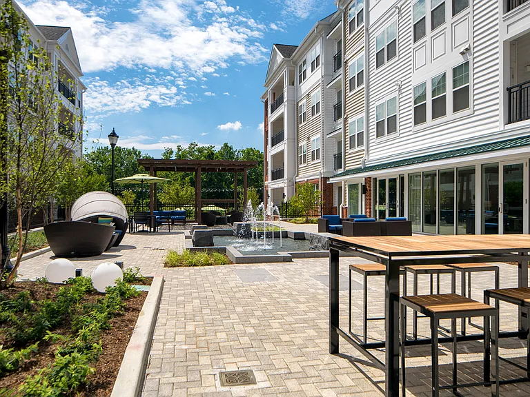 Courtyard for outdoor living, offering gorgeous water feature, cabana, pergola lounge area and grilling station