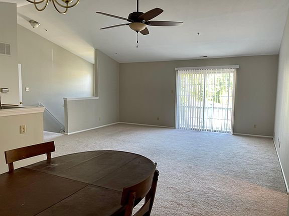 Living room with slider that leads to balcony