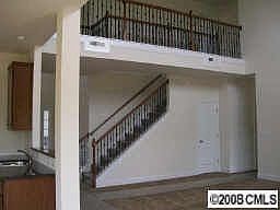 2 story family room w/wrought iron railing
