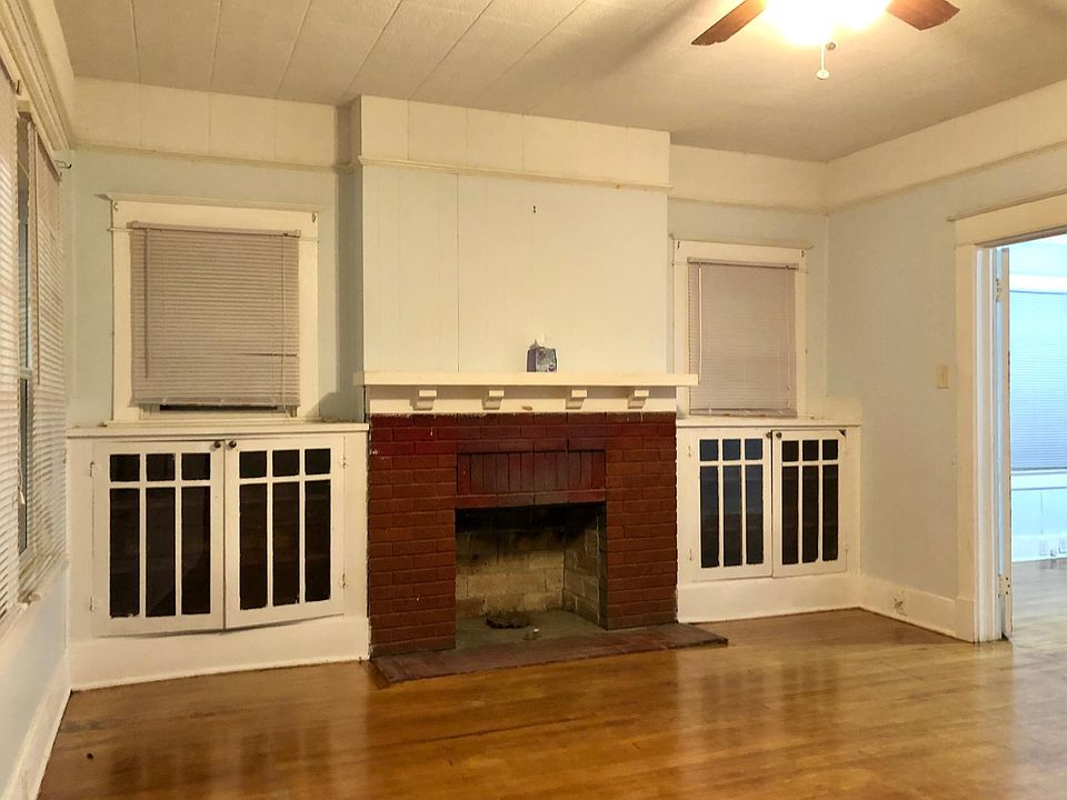 Large living room with original built- in cabinets.