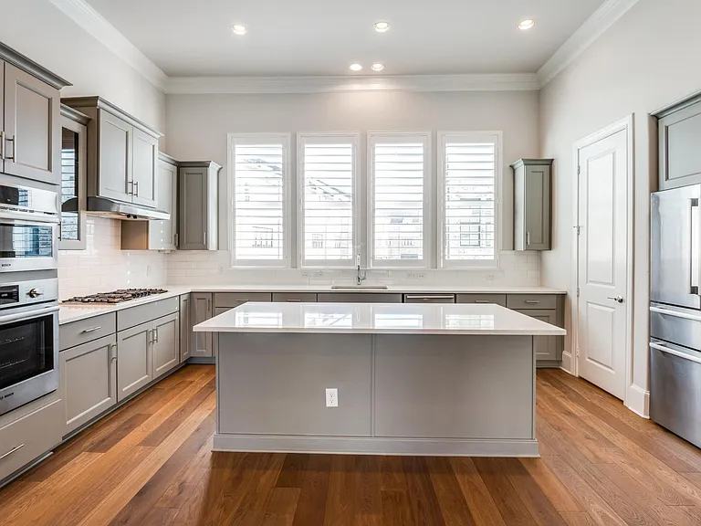 2nd floor kitchen featuring Bosch stainless steel appliance, gas cooktop, wine cooler, plantation shutters and pantry with ample storage space.