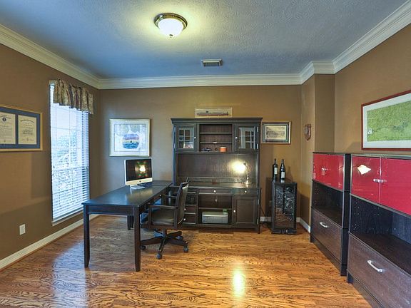 Another angle of the spacious home office. Note wood floors and double crown.