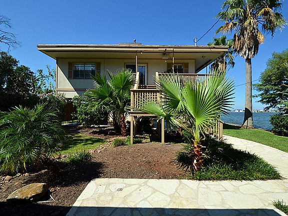 A view of the face of the home with beautiful landscaping and flagstone walkway.