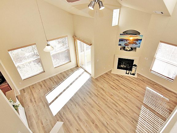 Living room with fire place and vaulted ceiling.
