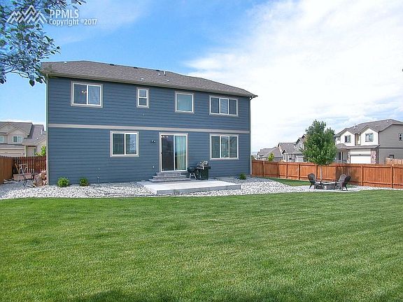 Back yard with extended patio and fire pit area.