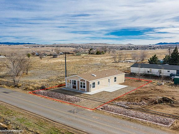 Nice covered deck & lots of windows!  Concrete walk around to large side patio!  2x6 construction, upgraded insulation, Low-E vinyl windows.  Ground set with concrete block foundation.