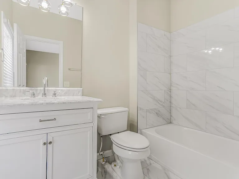 Second bedroom suite bathroom with top-of-the line Italian tiles and new installed vanity