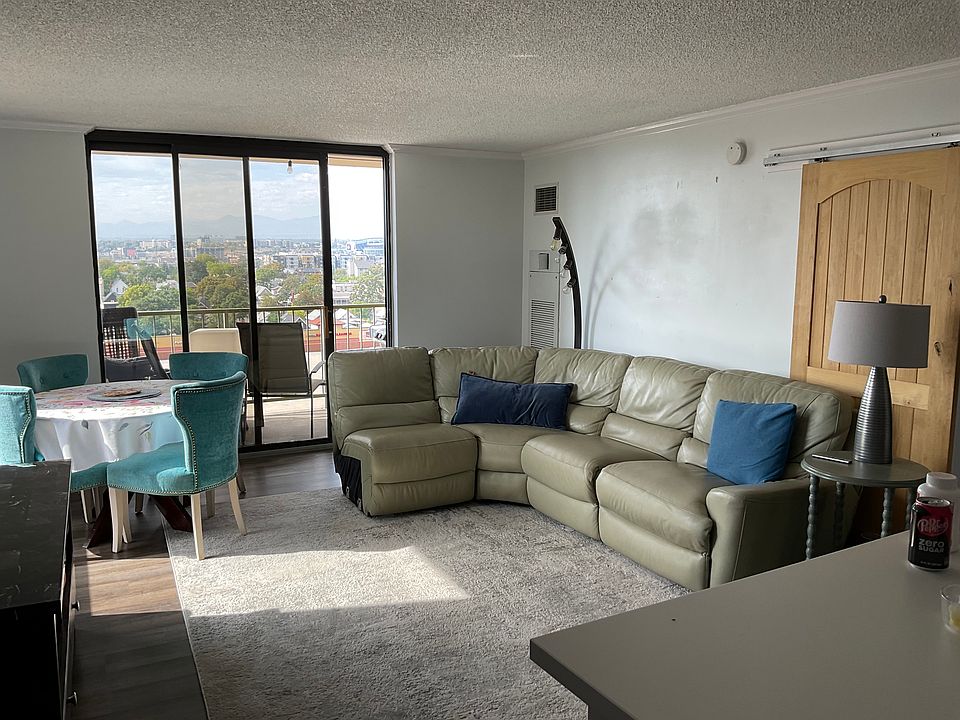 Open floor plan living room with sliding glass door to deck that has Mountain View's