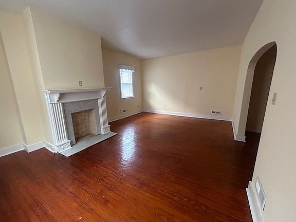 The living room faces the front of the house and can function as a dining room on one side and family room on the other.