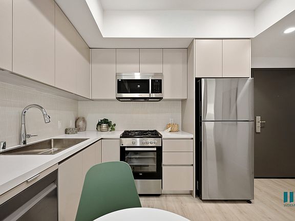 Kitchen with Stainless Steel Refrigerator, Stove, Microwave Oven, and Dishwasher