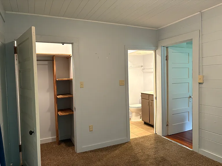 Bedroom 1, looking toward bath with Living Room to right