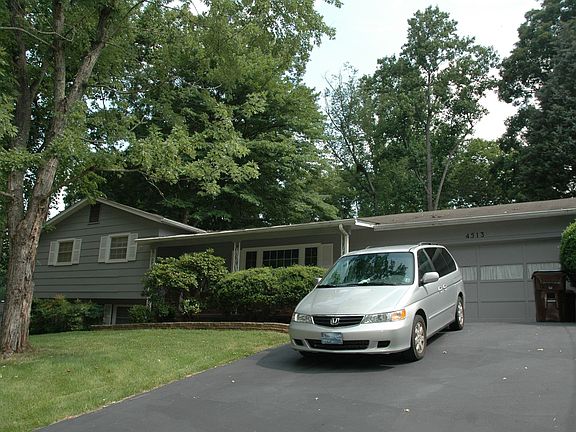 Large 2-car garage has built-in workbench & storage