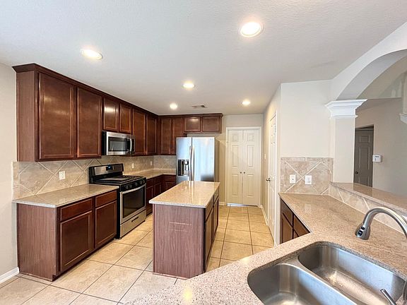 kitchen with cherry cabinets and granite countertop. Refrigerator is included