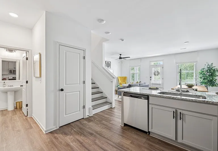 Spacious living area with easy access to the stairwell and upper levels.