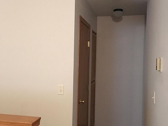 hallway with linen closet and coat closet 