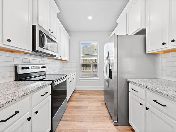 The kitchen has sprawling granite countertops.