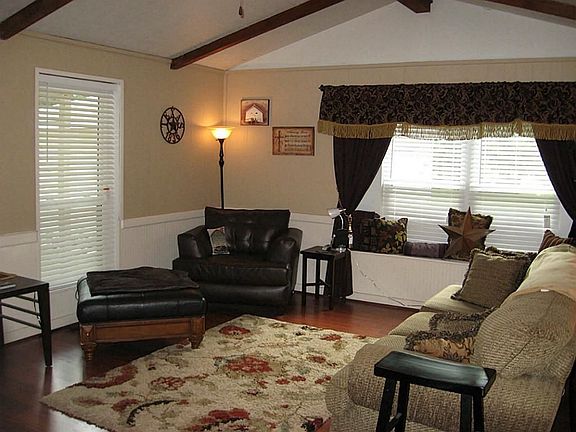 Another angle of Cathedral ceiling living room w/seating window.