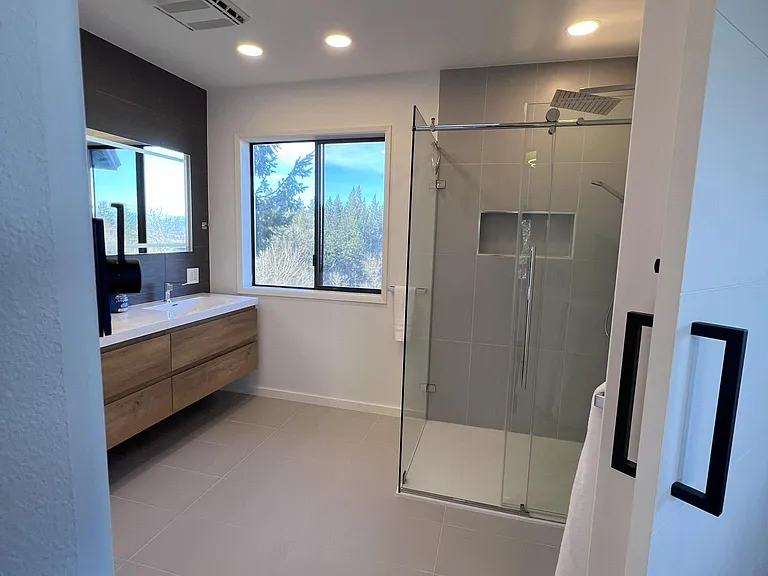Large walk-in shower and dual-sink vanities