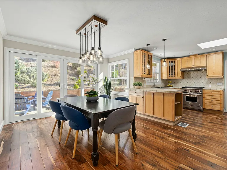 Kitchen / Dining room with sliding doors to the backyard for easy hosting, bringing the indoor and outdoor entertaining spaces together.