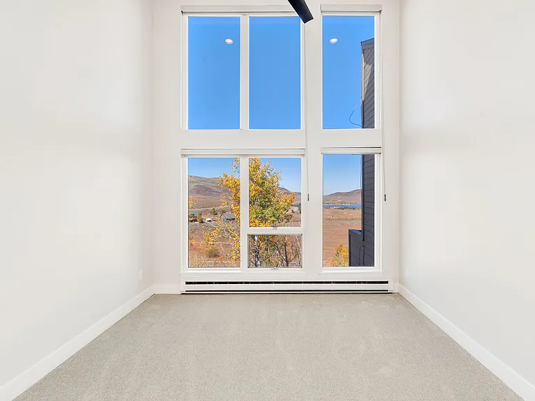 Bedroom #3 - on upper level. Floor to ceiling windows with electric black out window shades.