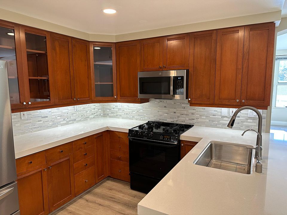 Modern, newly renovated kitchen finishes with solid surface stone counter tops and stainless steel appliances throughout.