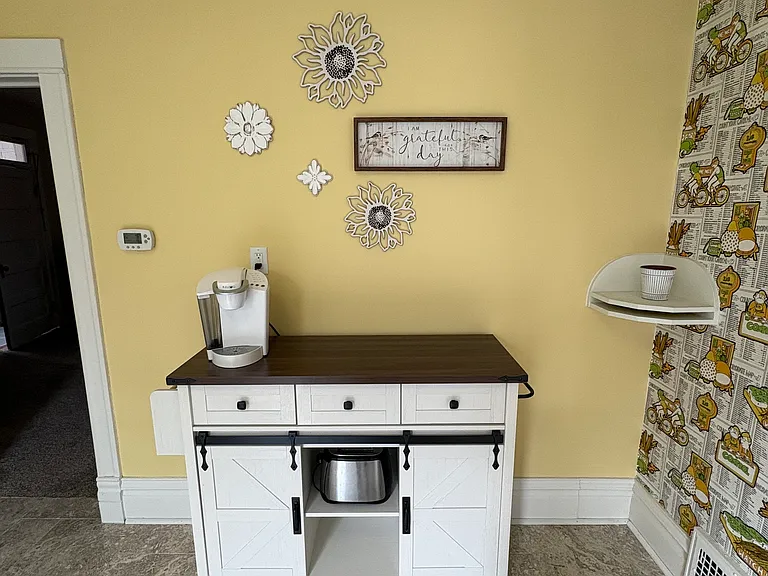 Mobile island with power source can be pulled out into the kitchen. One side of the island folds up and can be used as a small table. Two barstools included.