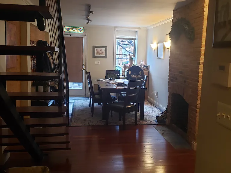 First story living room showing floating staircase looking toward the front door.